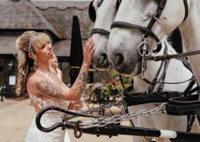 Bride strokes horses nose