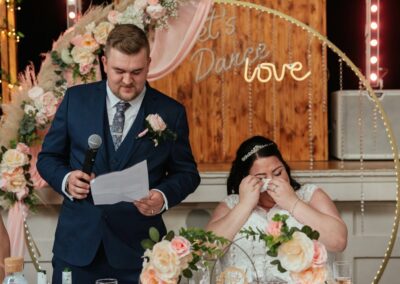 Bride wipes tear at grooms wedding speech