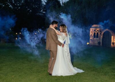 Couple embrace in front of smoke bomb