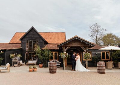 Couple with their beautiful barn wedding venue