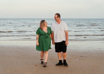Couples engagement shoot walking on the beach