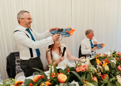 Fun with Nerf guns during the speeches as groom shoots guests