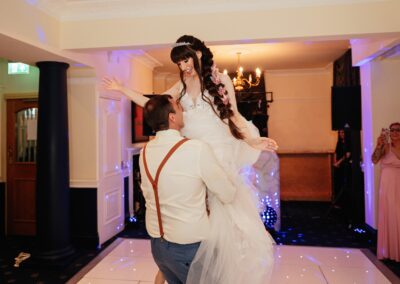 Groom lifts bride in epic dance floor routine