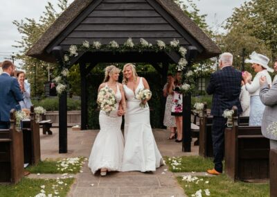 Two brides walk back down aisle at Channels