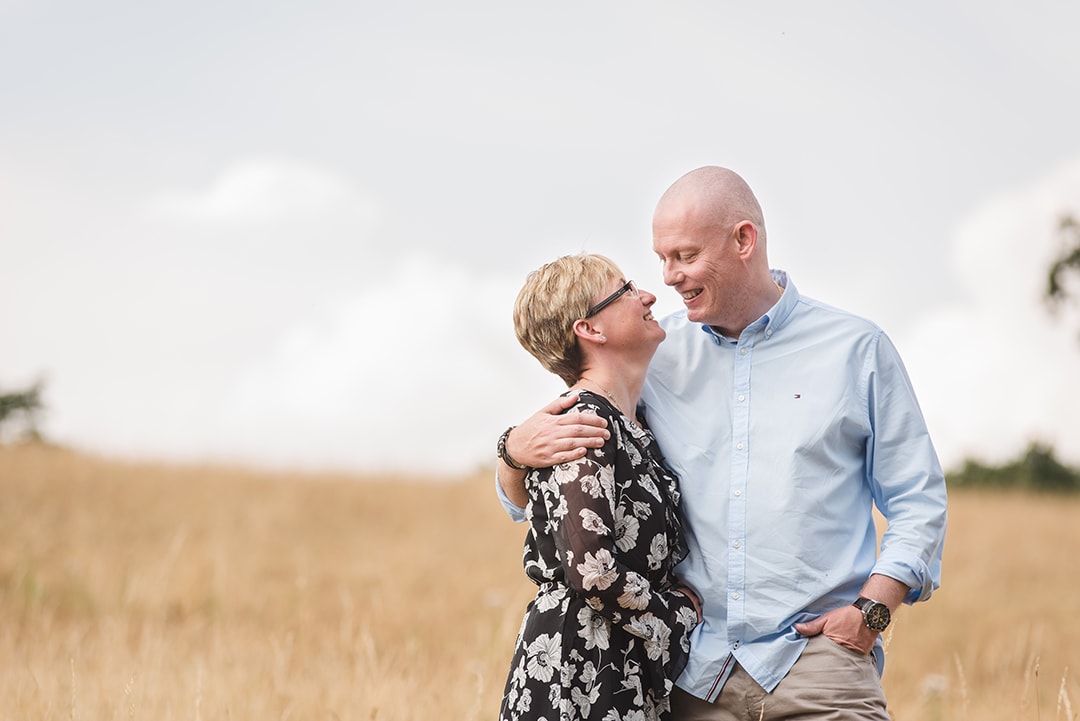 couple look to each other in anniversary photo shoot